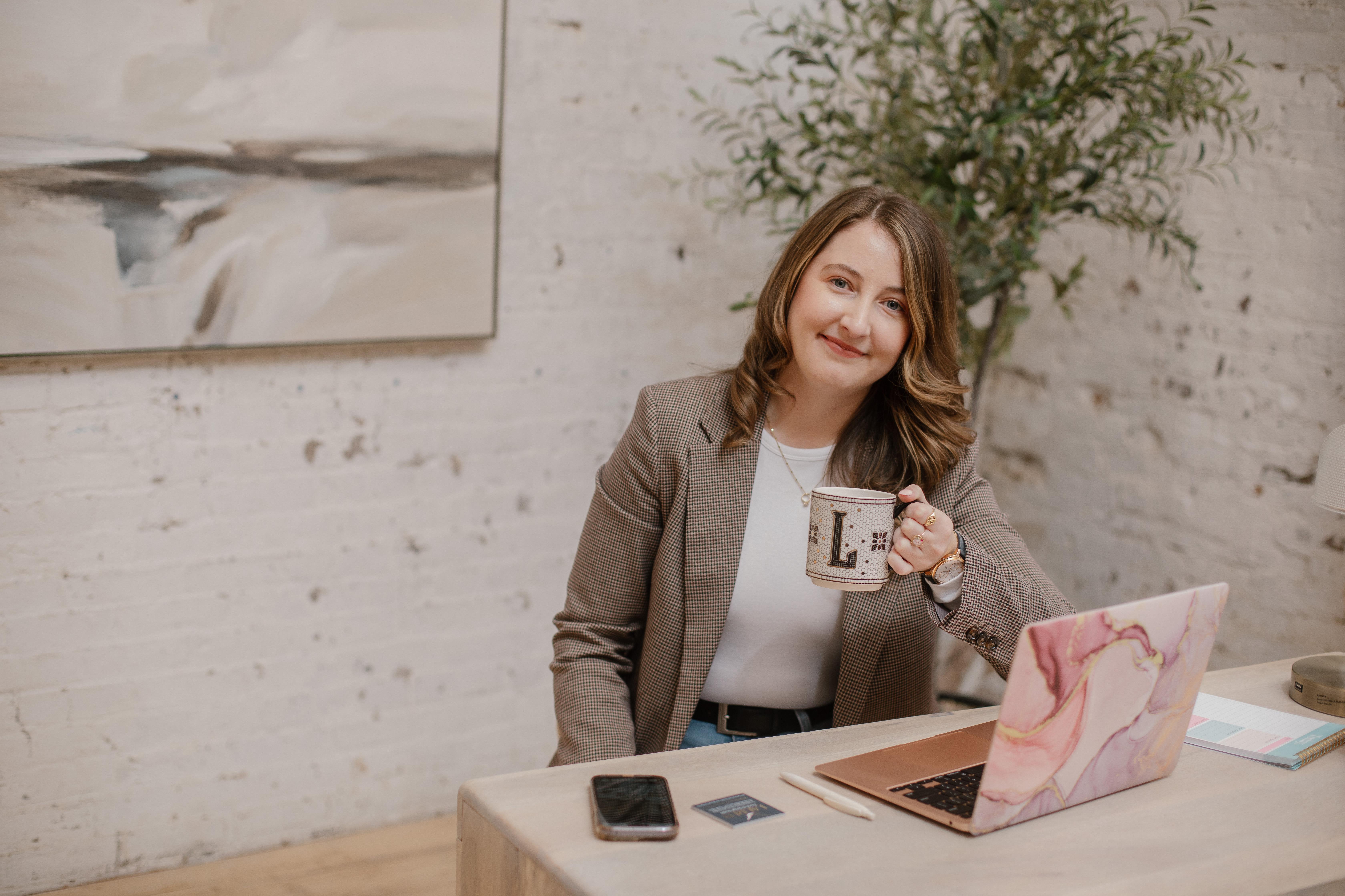 Lauren sitting in a chair with a coffee cup